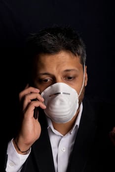 Young handsome with medical mask talking on his phone