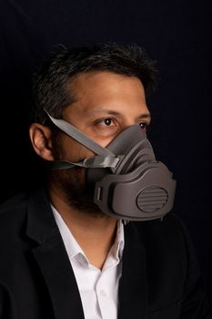 Young handsome with industrial mask to prevent the spread of contagious viruses or chemical gases