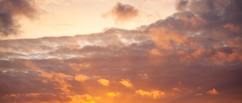 Dramatic sky with orange clouds over the city before dawn or sunset. Weather before or after a storm.