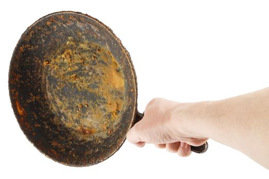 bare caucasian hand holding empty old cast iron frying pan - isolated on white background