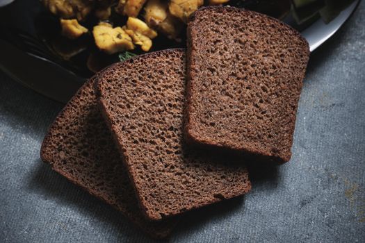 Three pieces of black bread close up