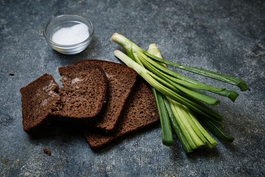 Bread with salt, green onions with water droplets