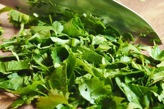 Sliced fresh parsley on a wooden cutting board