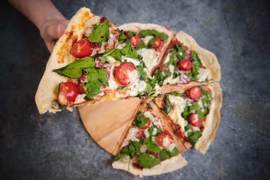 Pizza with cheese, tomatoes, spinach and smoked sausage