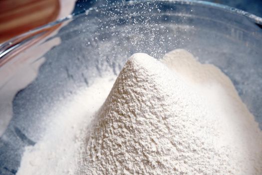 Flour is sieved with a metal sieveм