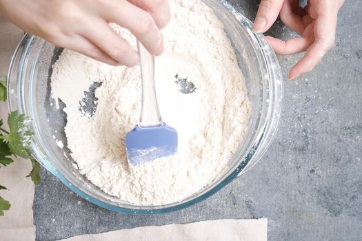 Flour is sieved with a metal sieve