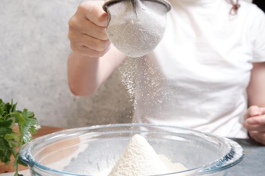 Flour is sieved with a metal sieve