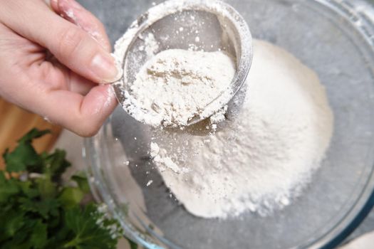 Flour is sieved with a metal sieve