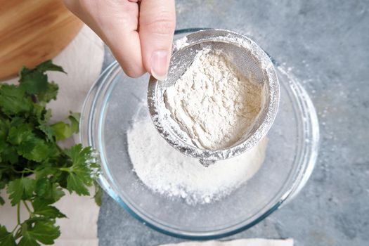 Flour is sieved with a metal sieve