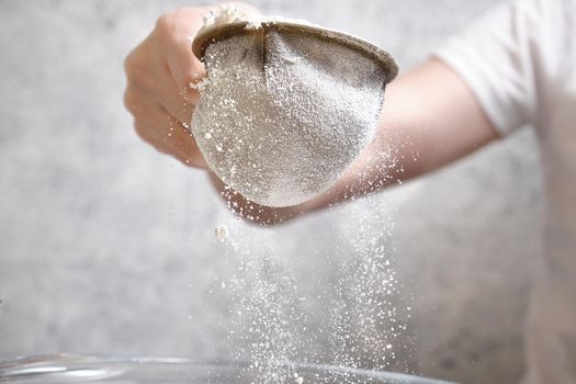 Flour is sieved with a metal sieve