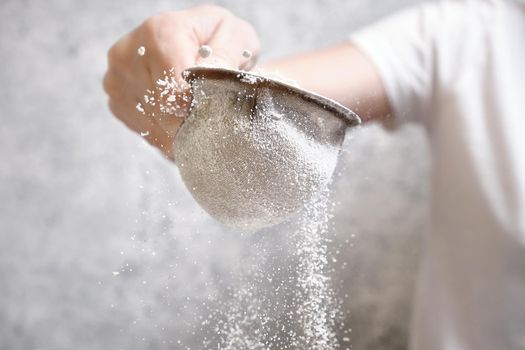 Flour is sieved with a metal sieve