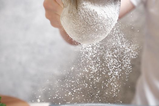 Flour is sieved with a metal sieve