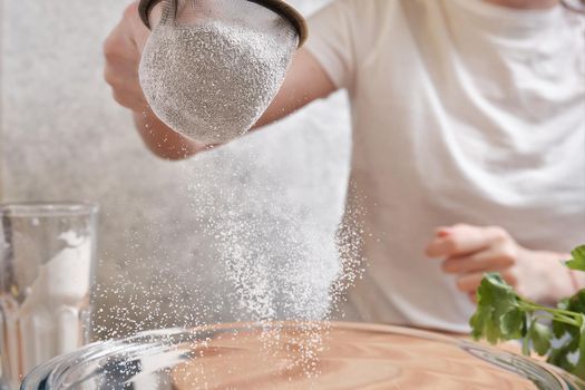 Flour is sieved with a metal sieve