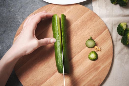 Chopping a cucumber on a cutting board