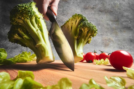 Knife cuts fresh cabbage on the board