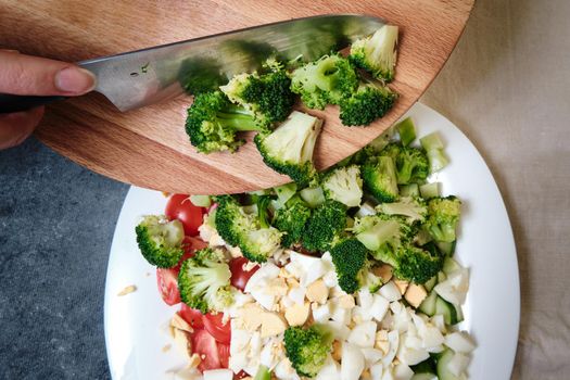 Plate with fresh vegetables and eggs, cut into pieces