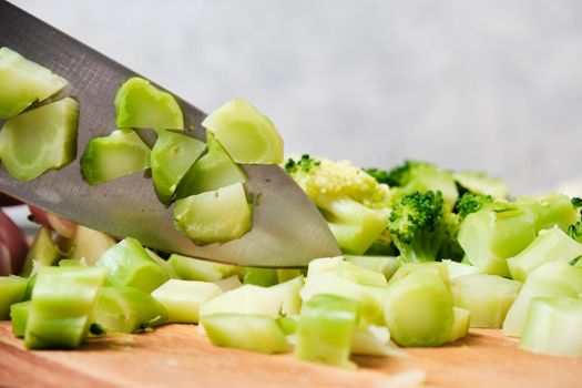 Cutting a fresh cucumber with a knife
