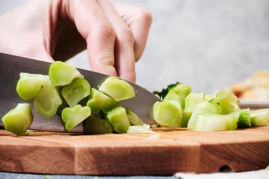 Cutting a fresh cucumber with a knife