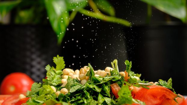 A plate of fresh vegetables and falling salt