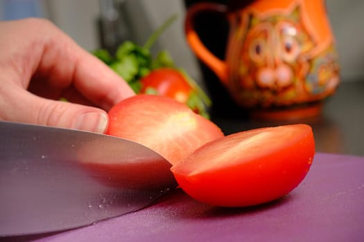 Slicing tomatoes on a cutting board with a knife