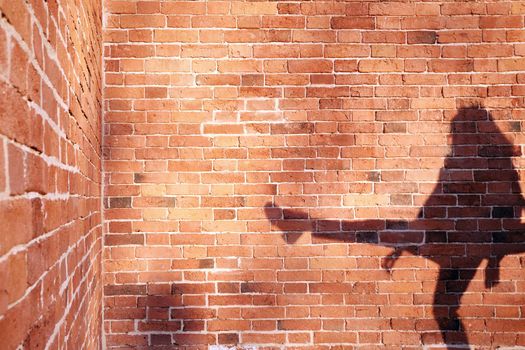 Shadow of a man on a brick wall background
