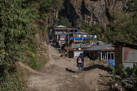 Young girl walking into a small mountain village, Annapurna circuit, Nepal