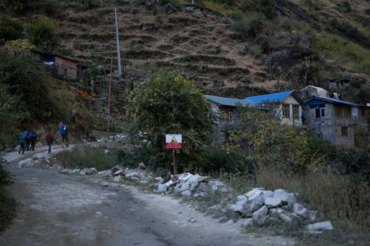 Group of five people trekking to a small mountain village, Annapurna circuit, Himalaya, Nepal, Asia