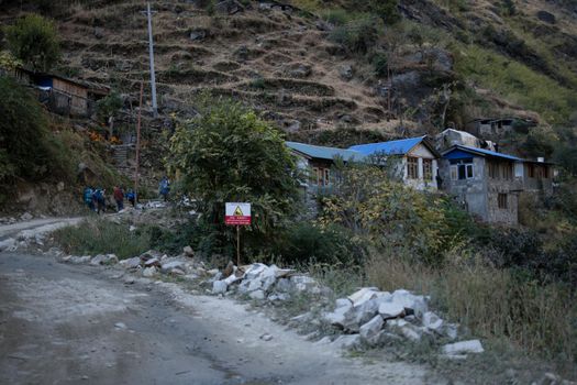 Group of five people trekking to a small mountain village, Annapurna circuit, Himalaya, Nepal, Asia