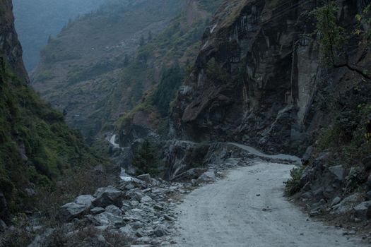 Dangerous curvy winding mountain road at Dharapani village over Marshyangdi river, Annapurna circuit, Himalaya, Nepal, Asia