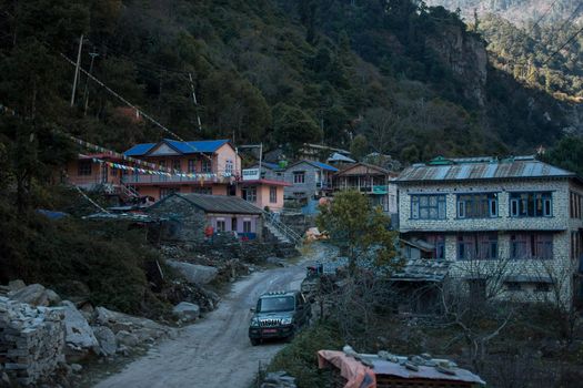 Nepalese mountain village with buddhist prayer flags along Annapurna circuit, Himalaya, Nepal, Asia