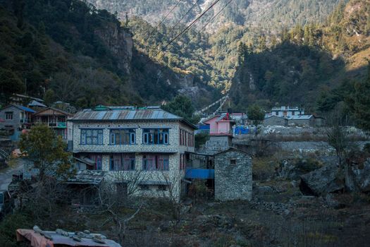 Nepalese mountain village with buddhist prayer flags along Annapurna circuit, Himalaya, Nepal, Asia