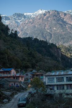 Nepalese mountain village with buddhist prayer flags along Annapurna circuit, Himalaya, Nepal, Asia