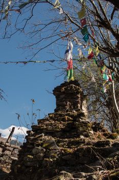 Colorful buddhist prayer flags hanging, blowing in the wind by the mountains