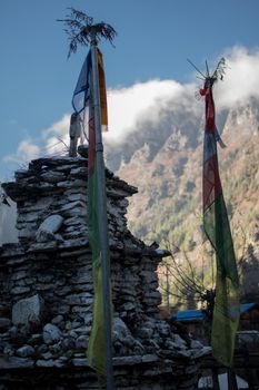 Colorful buddhist prayer flags hanging, blowing in the wind by the mountains