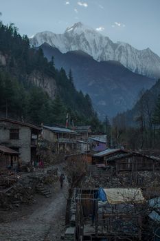 Two hikers trekking through nepalese mountain village, Annapurna circuit, Himalaya, Nepal, Asia