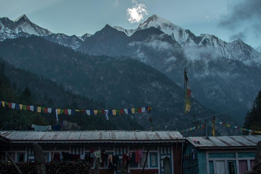 Buddhist prayer flags by the nepalese snow covered mountains, Anapurna circuit, Himalaya, Nepal, Asia