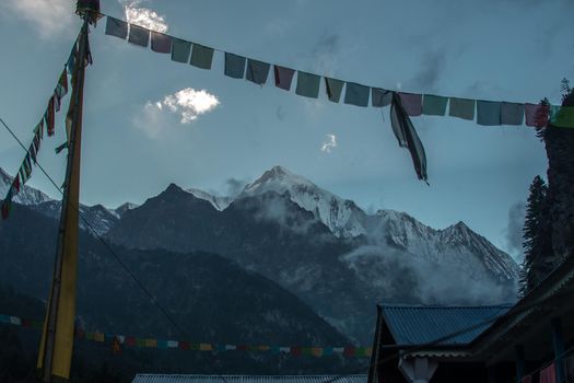 Buddhist prayer flags by the nepalese snow covered mountains, Anapurna circuit, Himalaya, Nepal, Asia