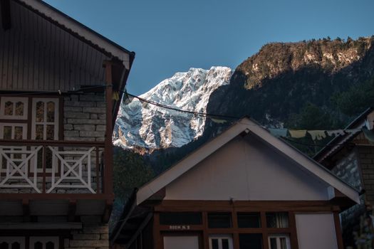 Nepalese Chame mountain village with snowy mountain, Annapurna circuit, Nepal, Asia