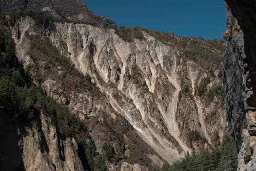 Trekking Annapurna circuit, mountain side by Marshyangdi river, Himalaya, Nepal, Asia