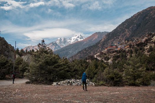 Backpackers by Upper Pisang and surounding mountains, trekking Annapurna circuit, Nepal