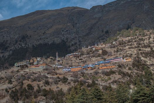 Upper Pisang mountain village in sunlight, trekking Annapurna circuit, Himalaya, Nepal, Asia