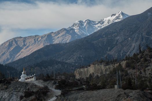 Snow-covered mountain and buddhist stupa by Upper Pisang, trekking Annapurna circuit, Nepal, Asia