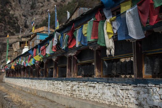 Buddhist prayer wheels and flags, Upper Pisang, trekking Annapurna circuit, Himalaya, Nepal