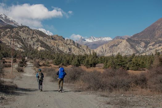 Backpacker friends surounded by mountains, trekking Annapurna circuit, Nepal, Asia