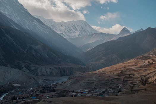 Mountain village by Marshyangdi river and surounding mountains, trekking Annapurna circuit, Nepal, Asia