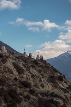 Buddhist stone monuments with prayer flags in the nepalese mountains, trekking Annapurna circuit