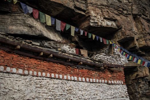 Buddhist prayer flags at Praken Gompa over Manang village, trekking Annapurna circuit