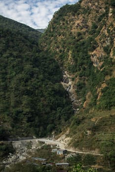 Beautiful waterfall flowing under a bridge at Annapurna circuit, Nepal