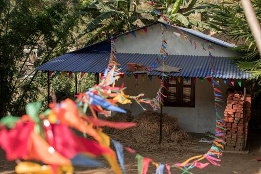 Buddhist praying flags attatched to a small house in a nepalese village, annapurna circuit