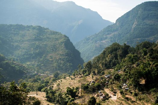 View over huts and terraced rice fields at Annapurna circuit in Nepal